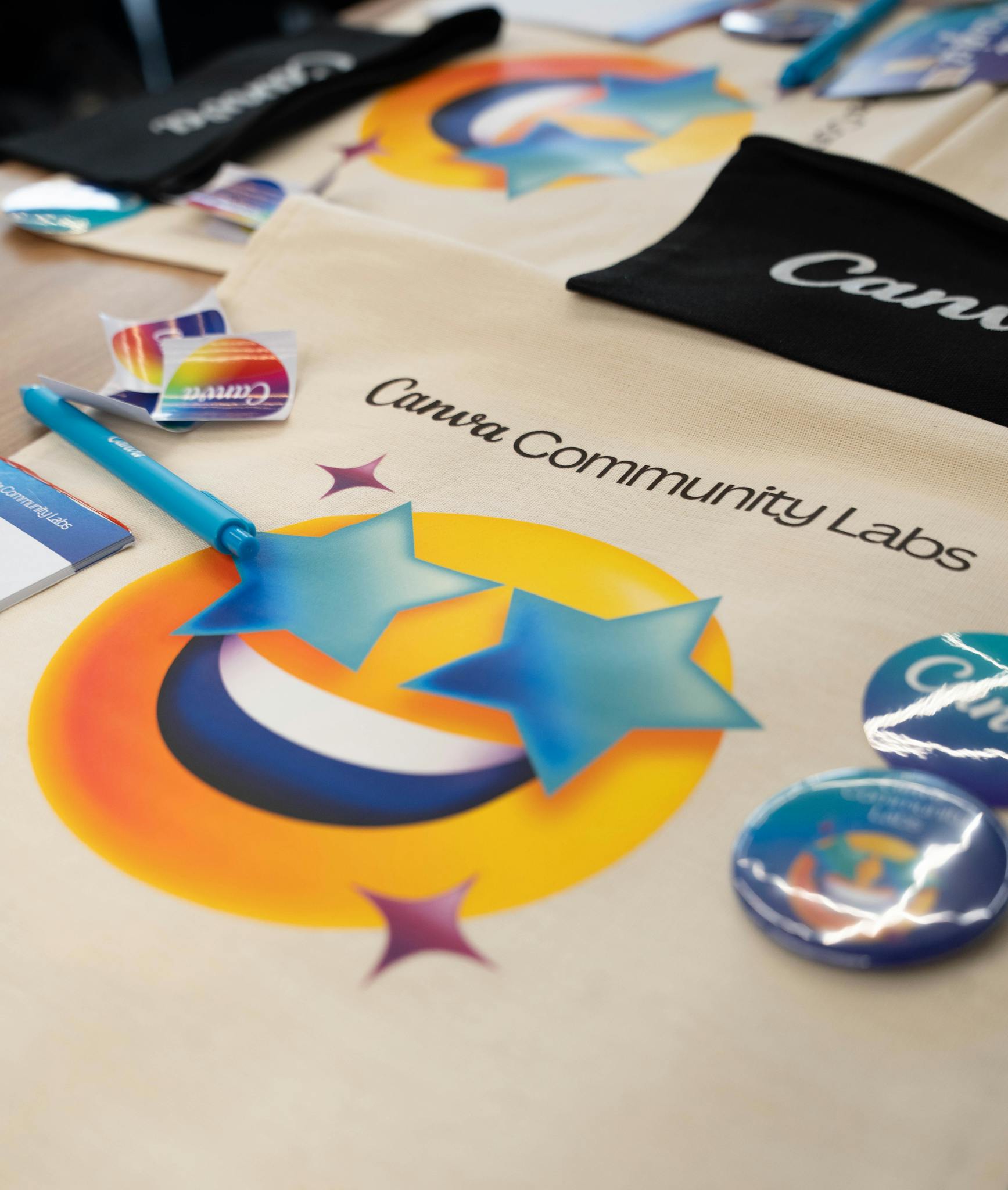 Creative display of Canva Community Labs merchandise showcasing branding and vibrant designs.